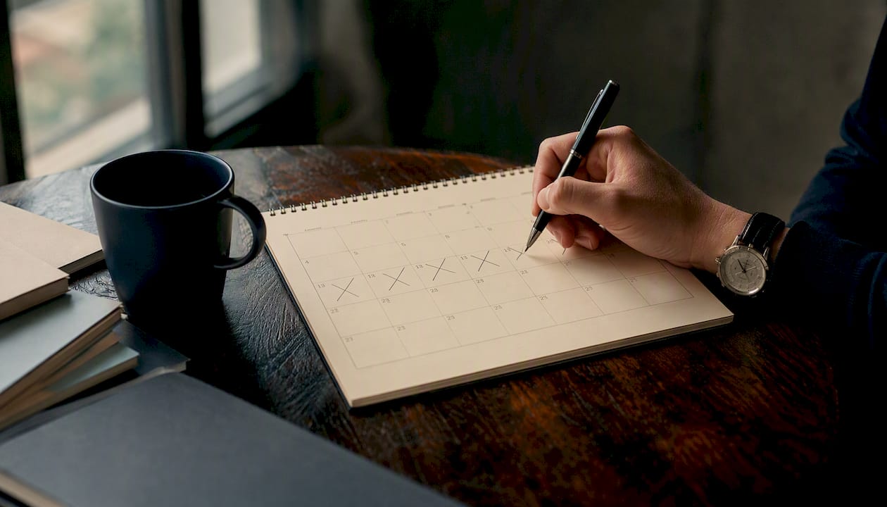 Hand marking steady shifts on calendar