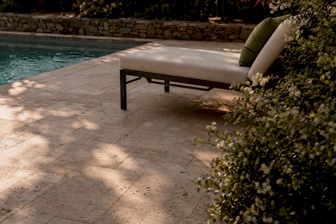 Travertine paver patio near pool with shade