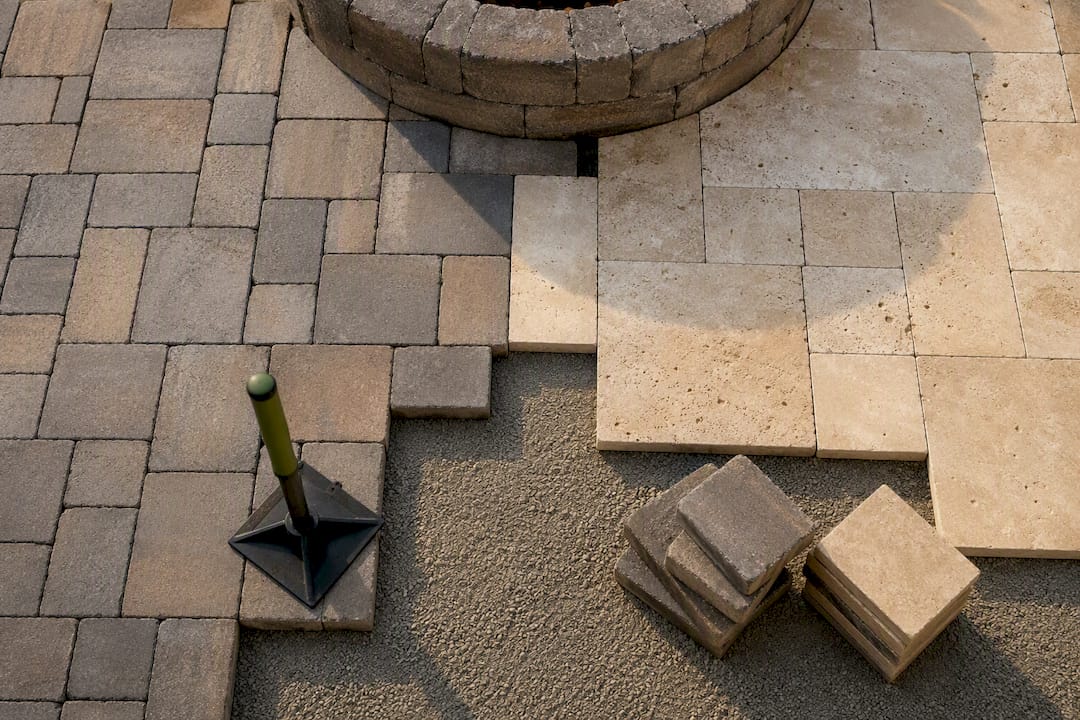 Pavers and travertine beneath fire pit