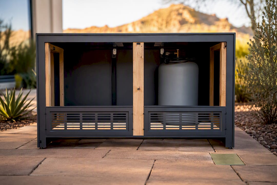 Opposing vents on a propane fire pit cabinet