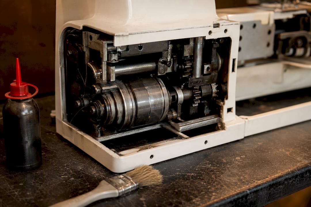 Close-up of metal sewing machine motor and gears