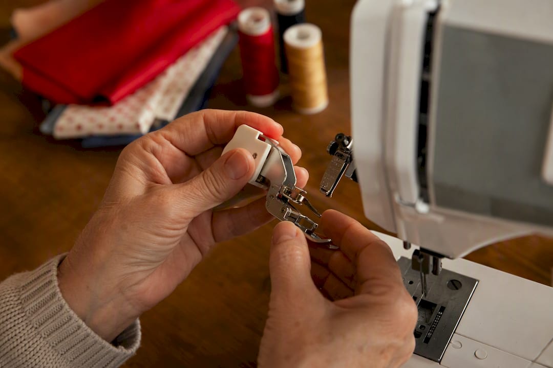 Hands attaching walking foot to sewing machine