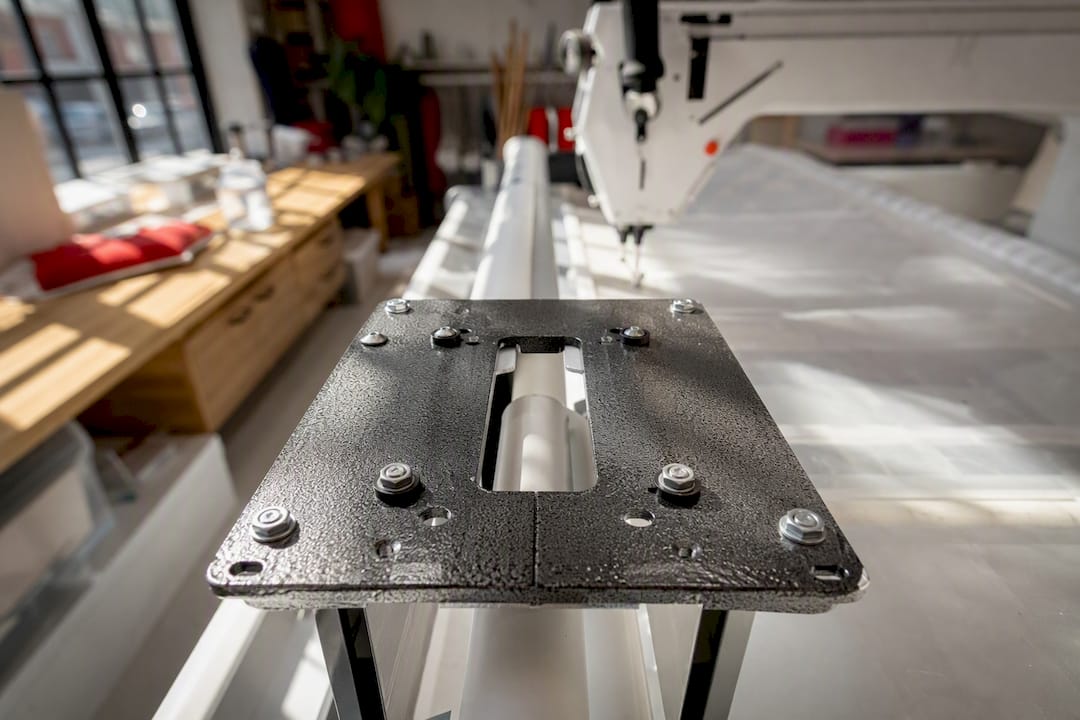 Quilt frame mounting plate close-up with machine