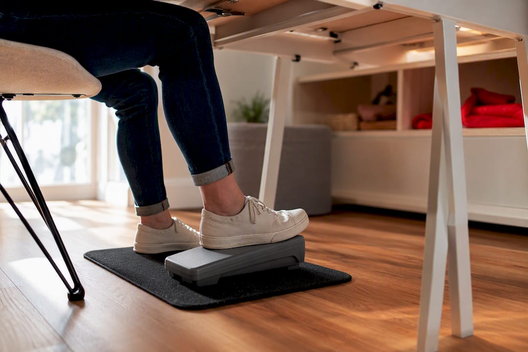 Foot using a pedal on non-slip mat