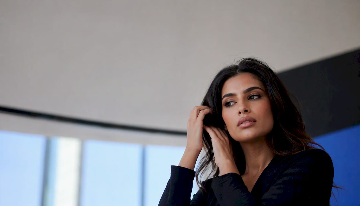 Commercial model on photoshoot applying lipstick