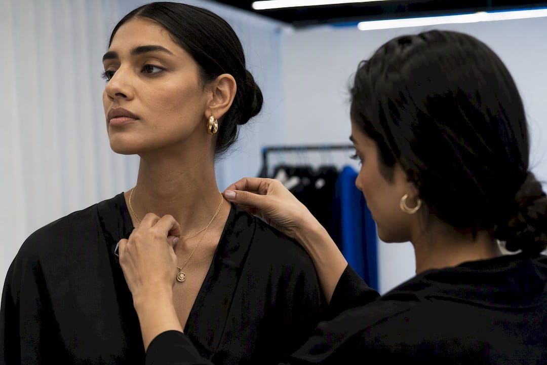 Stylist adjusting bracelet on model’s wrist