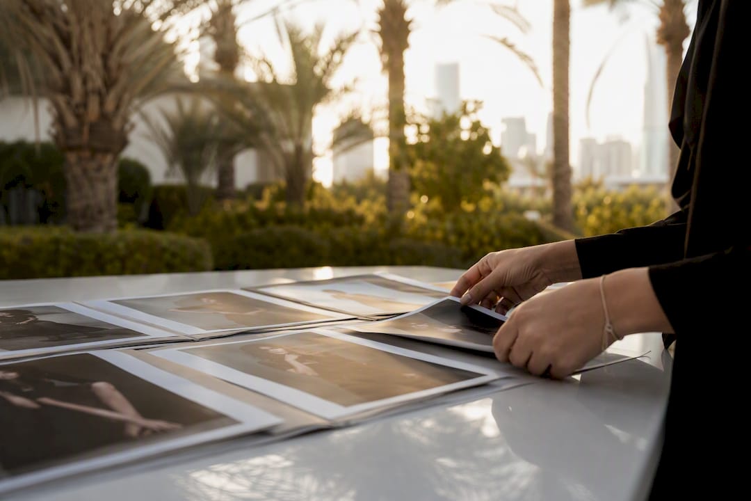 Hands reviewing model digitals on table