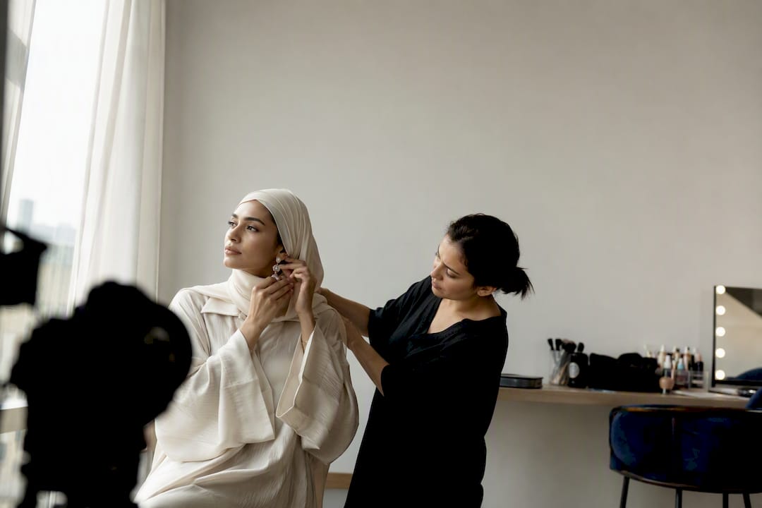 Model and stylist preparing portfolio in studio