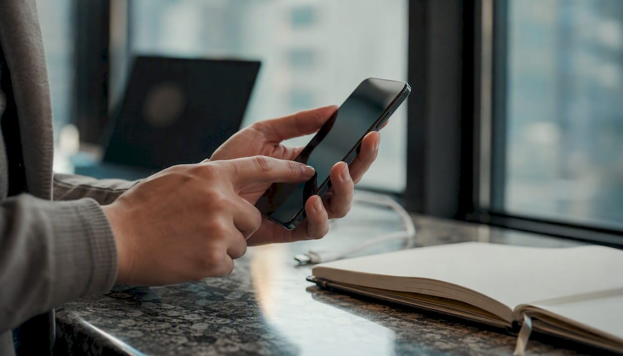 Hands manually testing app install on smartphone