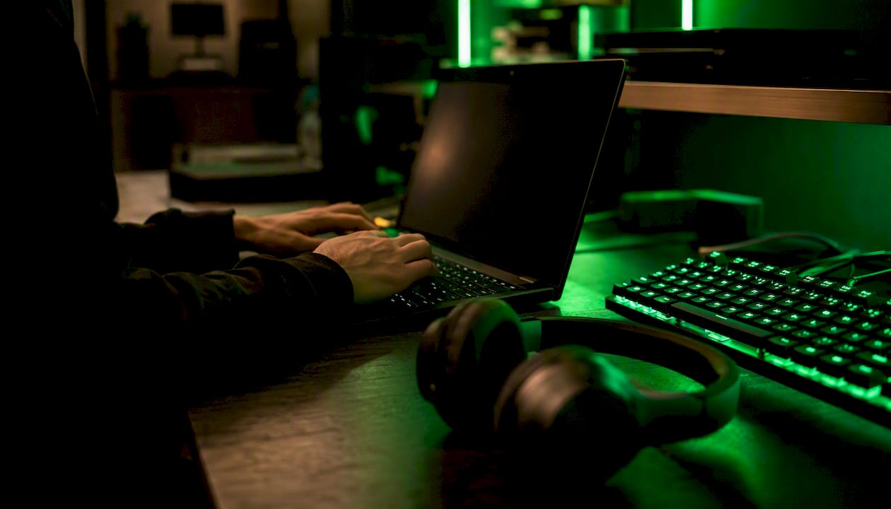 Gamer adjusting cheat settings on laptop