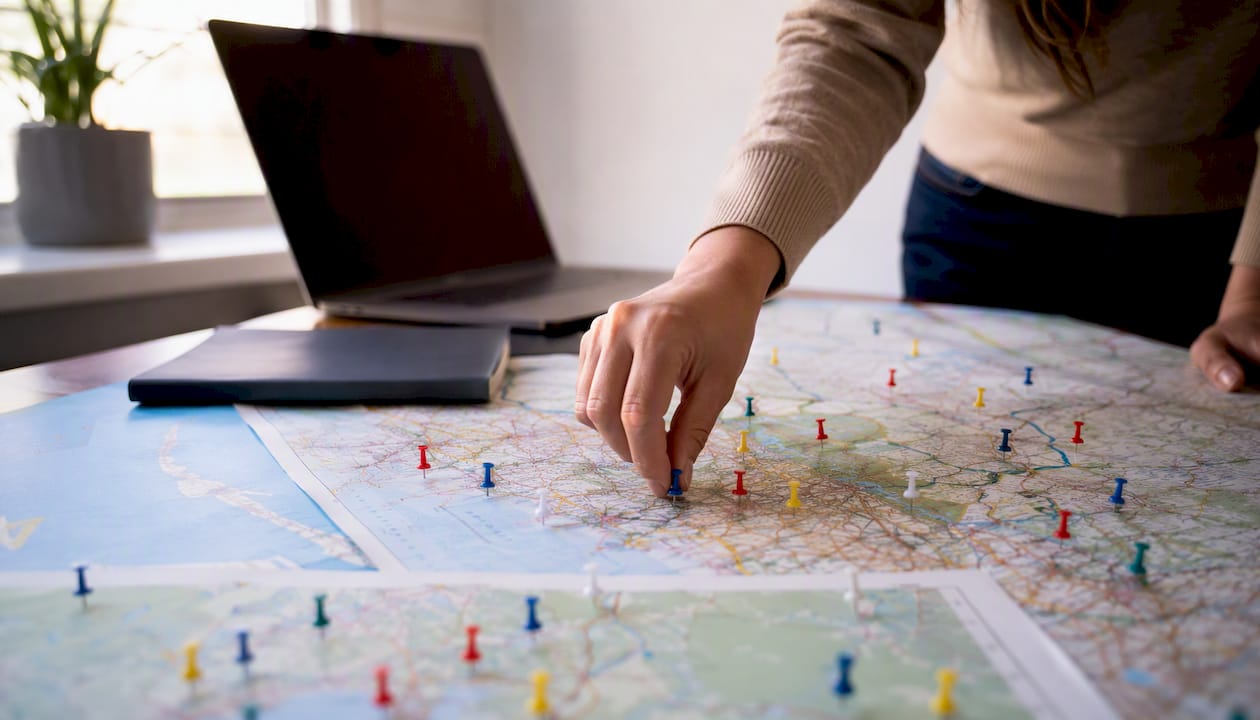 Hand placing location pin on map