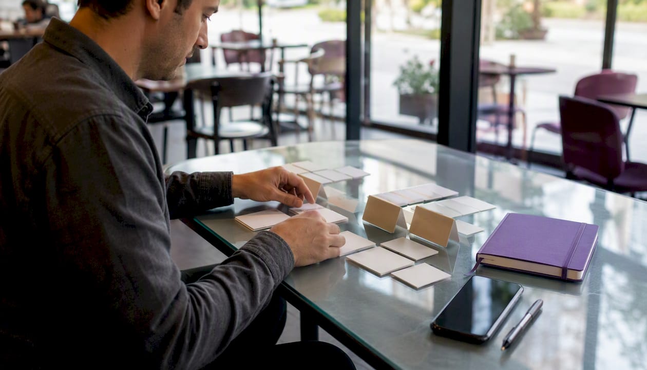 Hands arranging citation materials on table