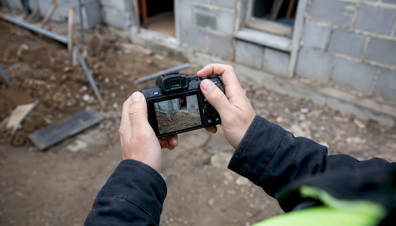 Hands photographing service job site exterior
