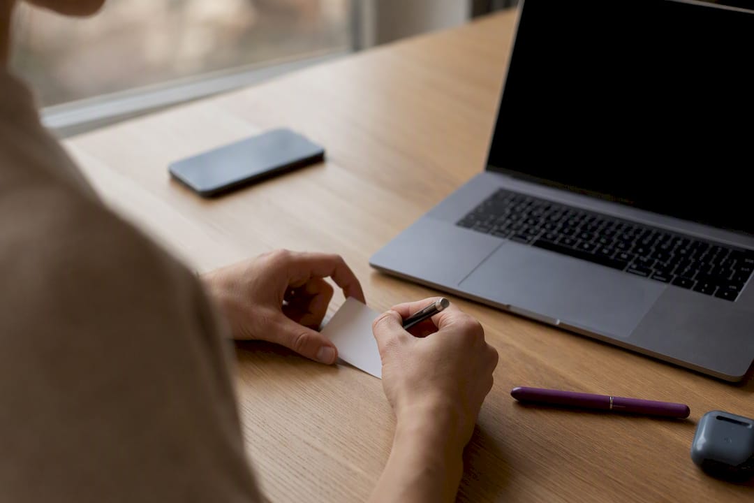 Hands writing on business card for citation