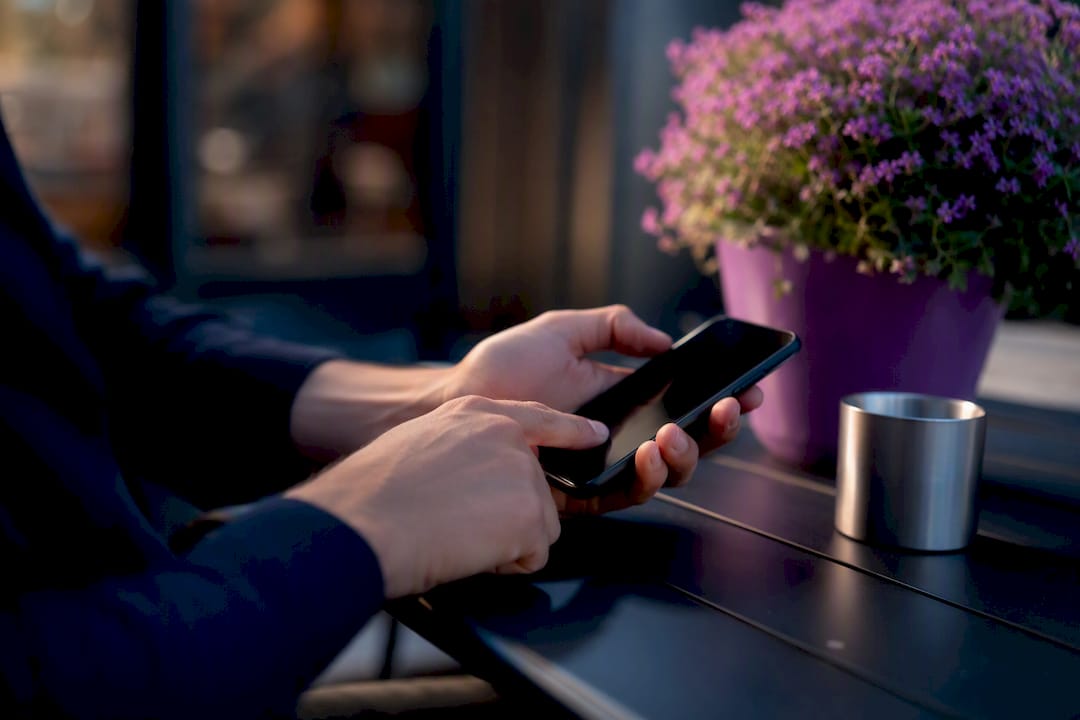 Hands updating business profile on smartphone