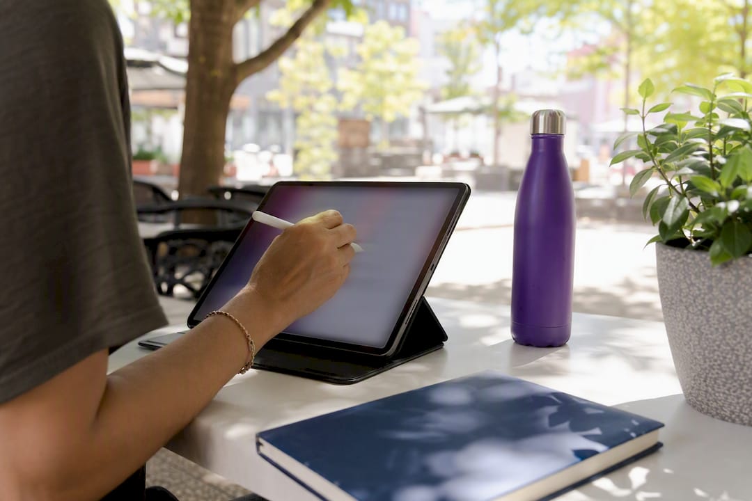 Hand using stylus on tablet with SEO checklist