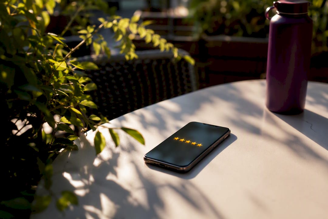 Close-up of smartphone with blurred five-star rating