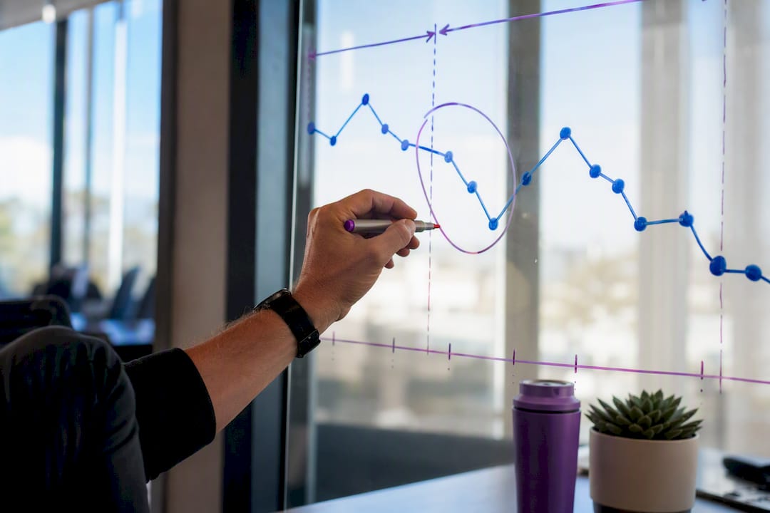 Hands annotating SEO ranking drop timeline