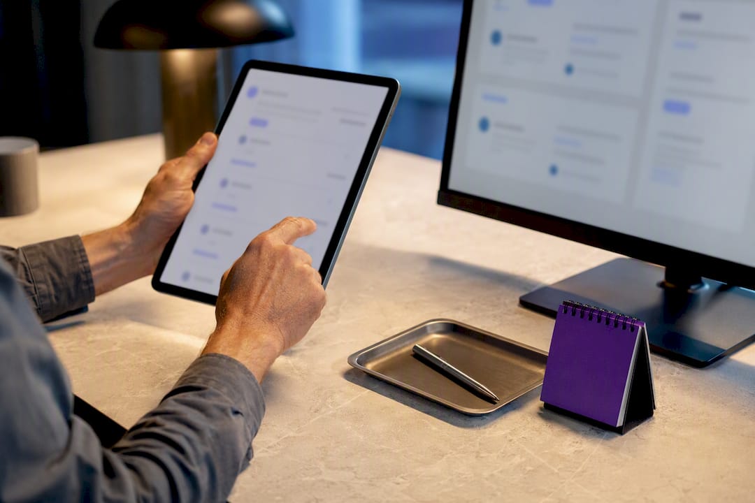 Hands comparing anonymous business listings