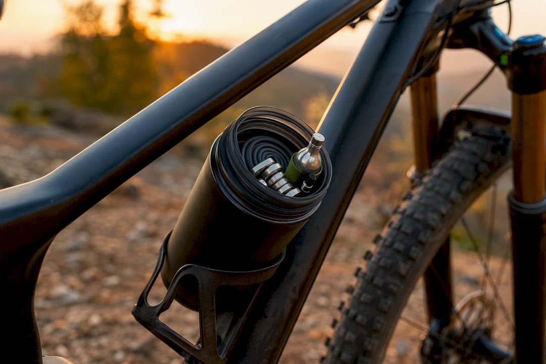Wide-mouth cycling tool bottle with packed tools
