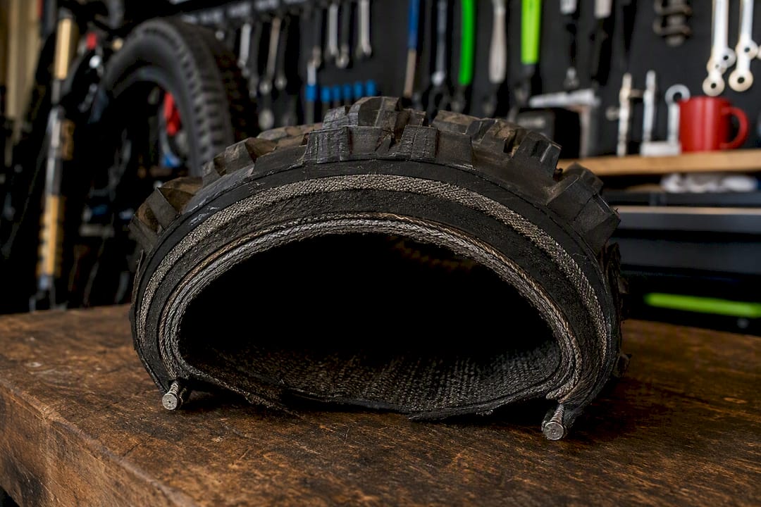 Cross-section of bike tire layers showing protection types