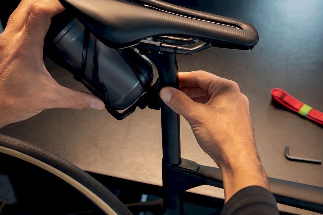 Hands checking saddle bottle clearance