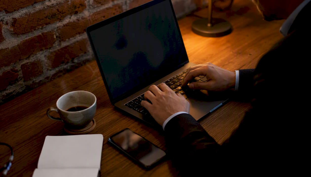 Manos trabajando en la configuración de una campaña de Google Ads sobre el escritorio