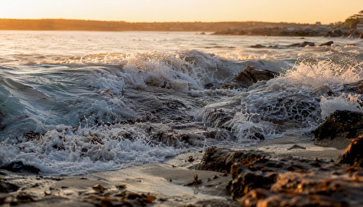 Breaking ocean wave over shallow coastal seabed