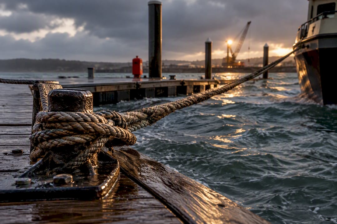 Mooring lines tightened by rising harbor water