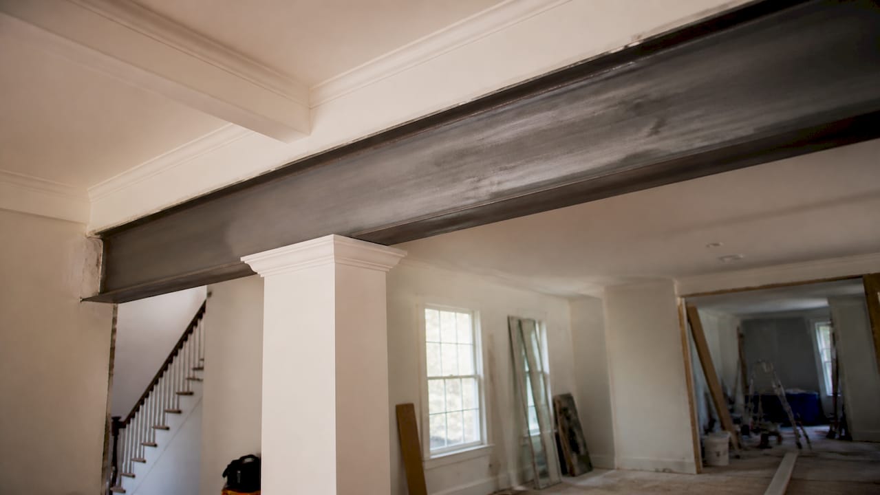Exposed steel I-beam in two-story home renovation