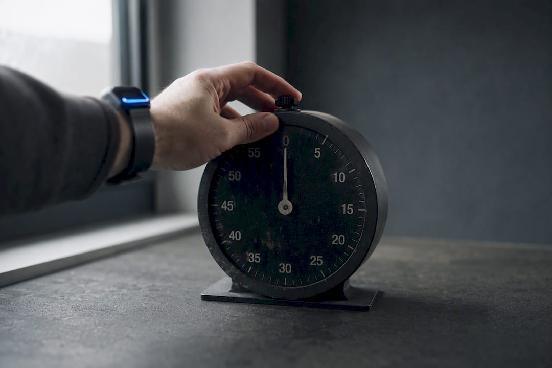 Hand pressing reset button on timer