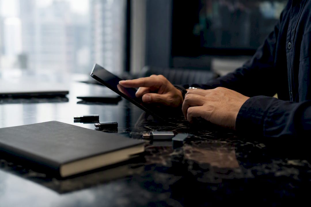 Trader hands near tablet and USB drives