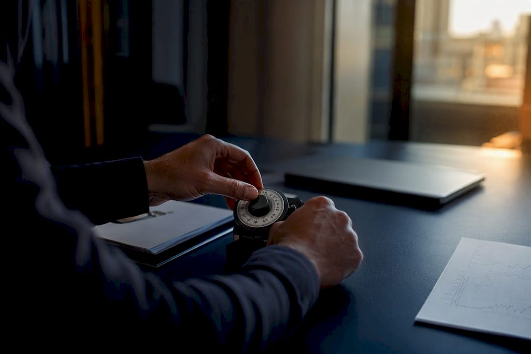 Hands adjusting trading evaluation dial