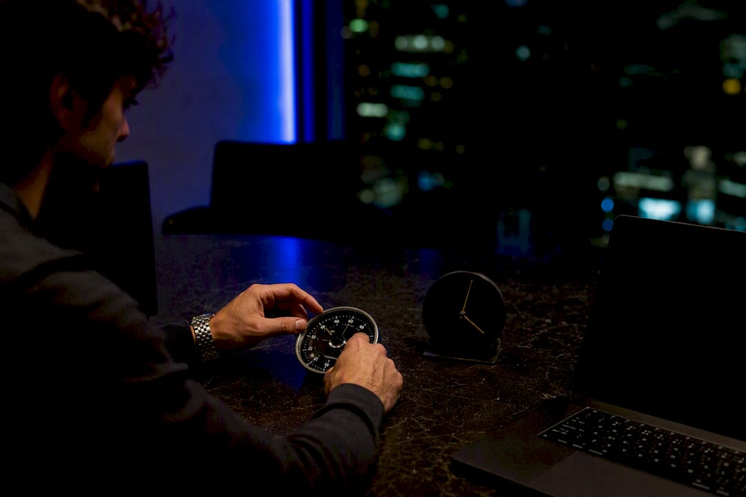 Trader adjusting swap cost dial on dark desk