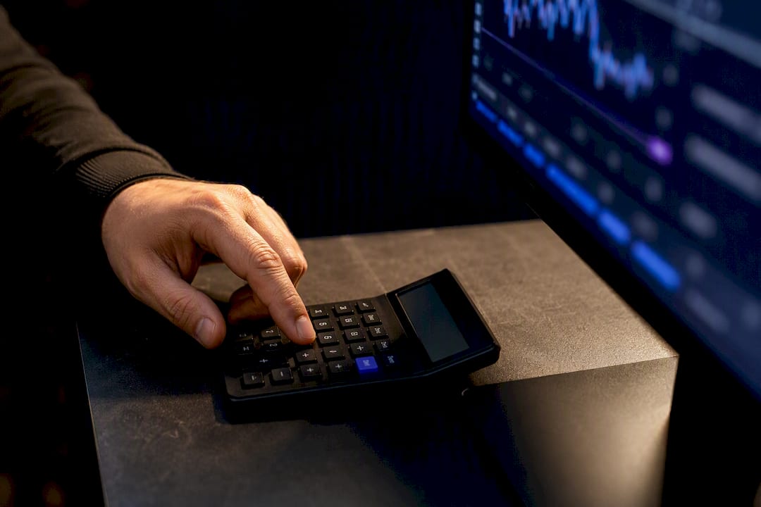 Trader calculating leverage risk at desk