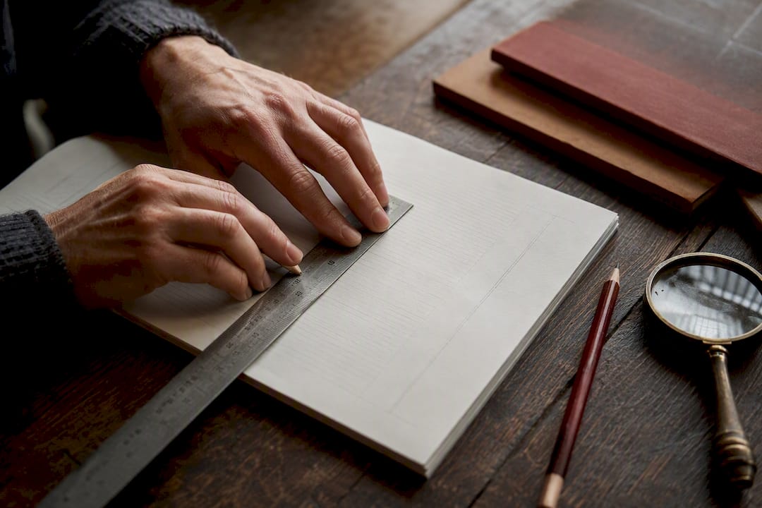 Hands adjusting text spacing on typesetting proof