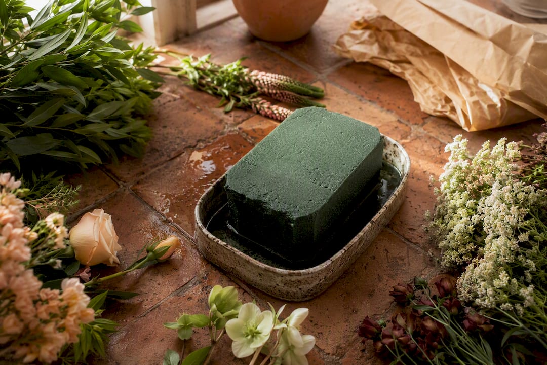 Green floral foam block on florist table