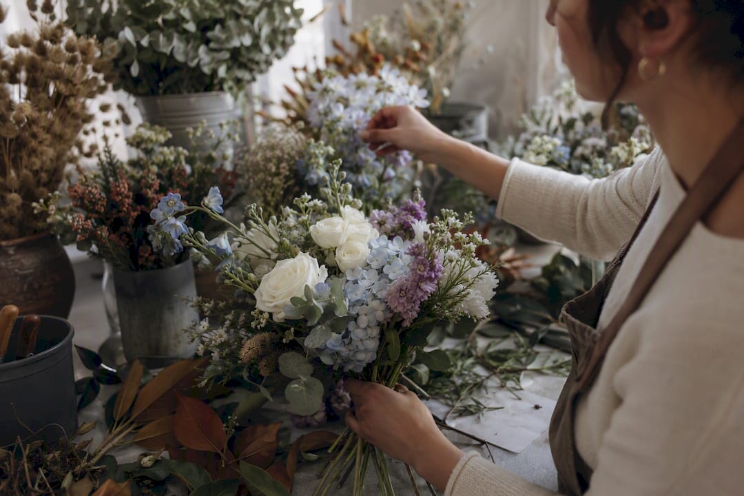 Florist assembling personalized memorial bouquet
