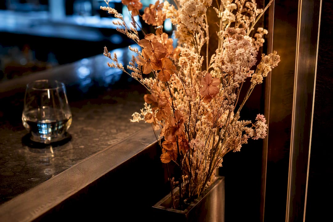 Preserved flower stems in restaurant bar alcove