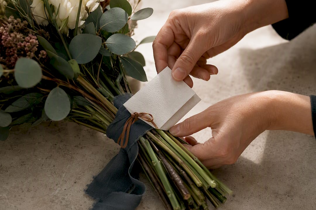 Handwritten note tucked into sympathy flowers