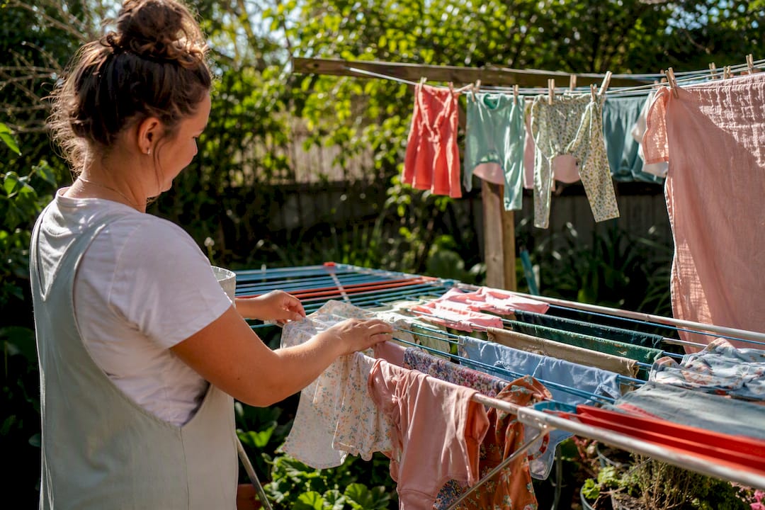 Hands air drying baby clothes flat