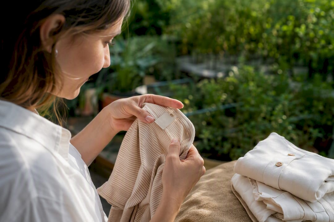 Hands examining kids clothing labels carefully