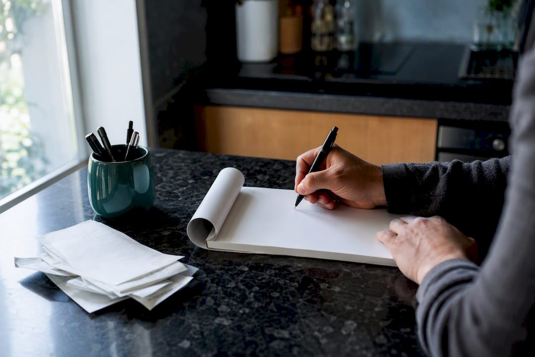 Hands writing invoice sequential number