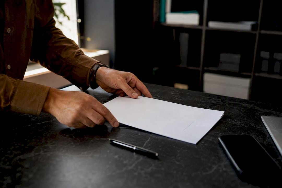 Hands placing signed property deed