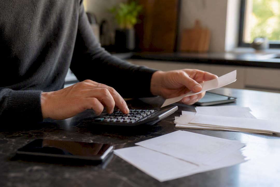 Hands calculating joint property tax