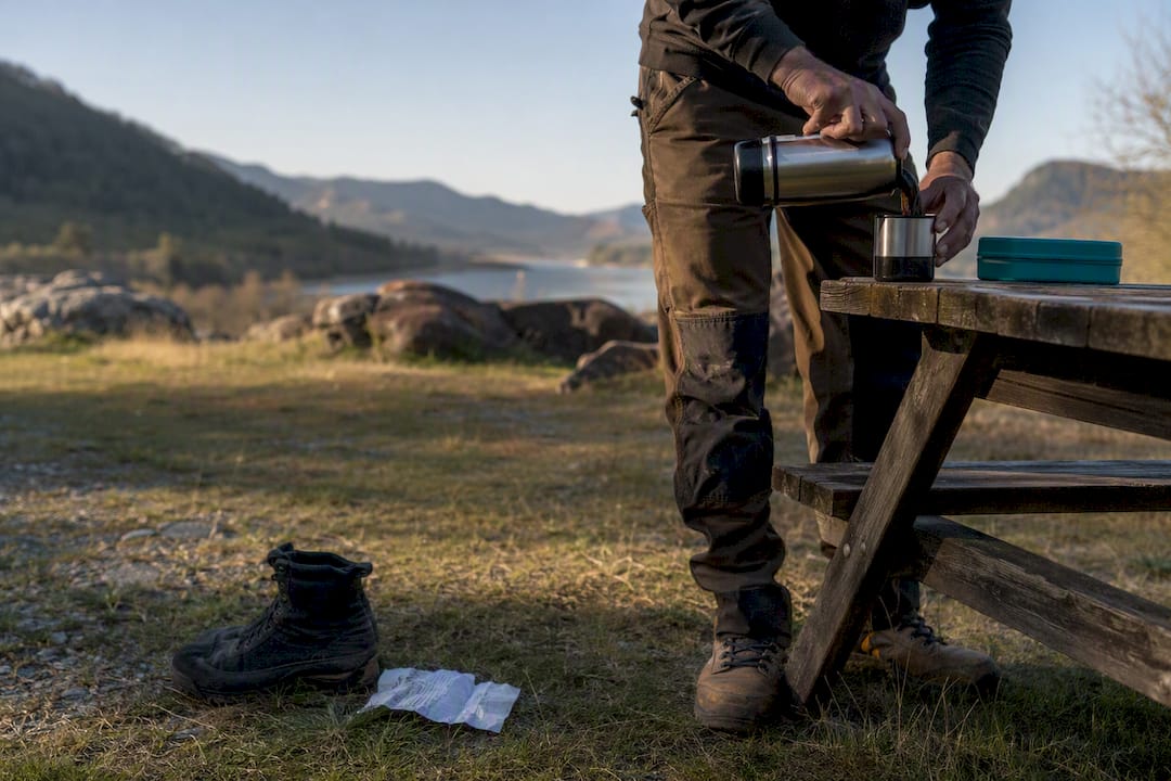 Hands pouring coffee during work break