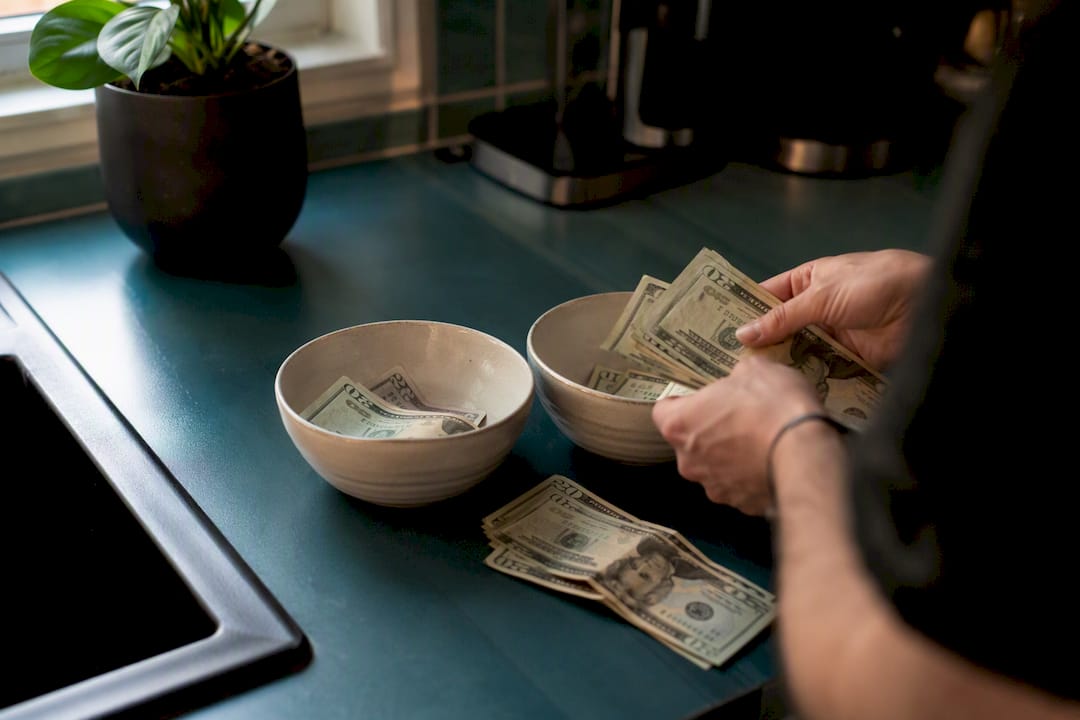 Hands budget cash into separate tax jars