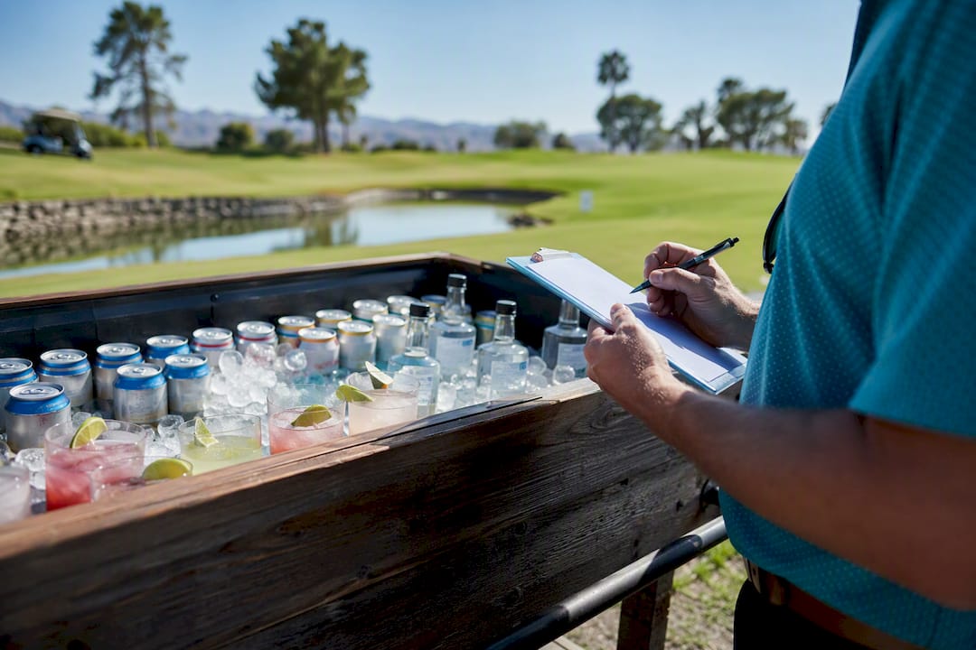Drinks arranged on golf cart tray outdoors
