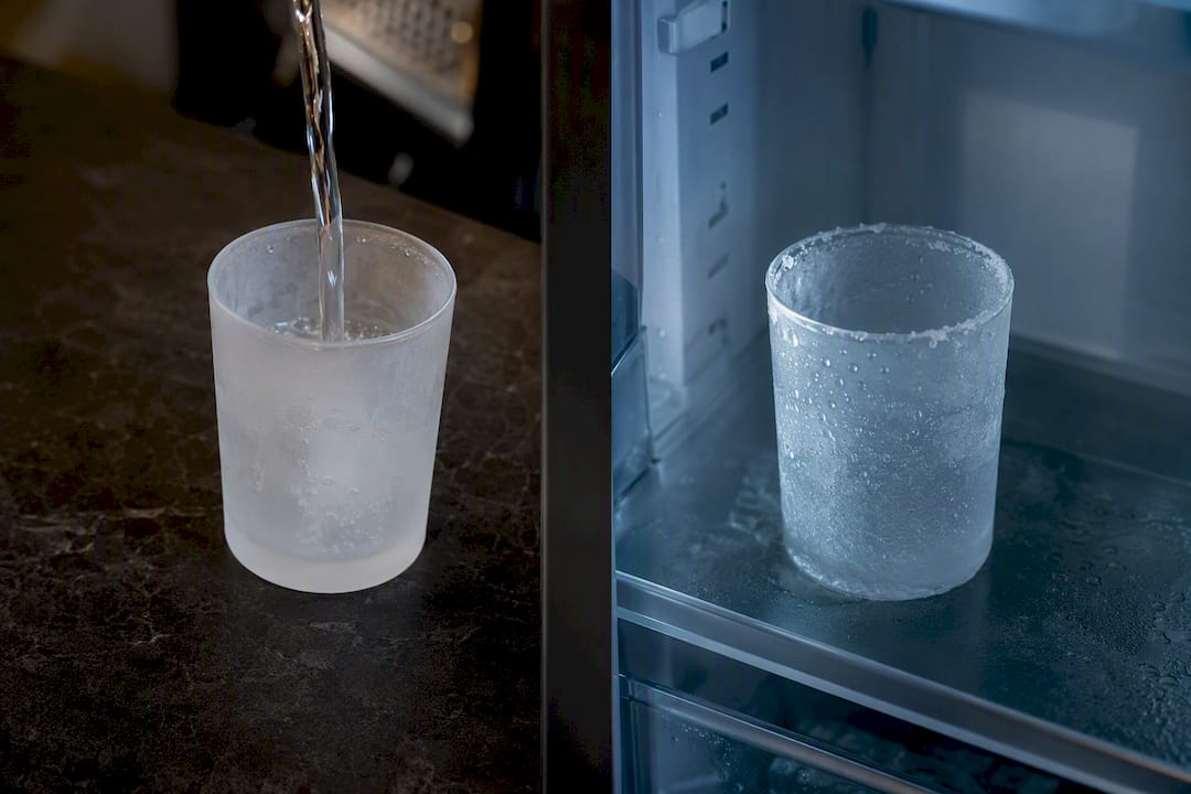 Vodka glass pouring in freezer and fridge