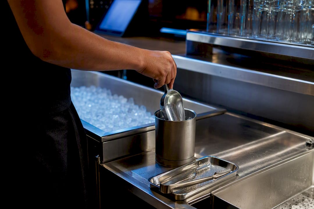 Dedicated ice scoop beside clean bar ice bin